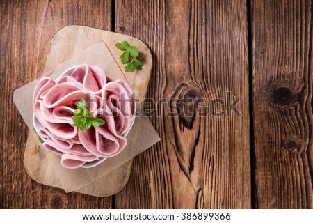 Cutted Ham Sausage on wooden background (selective focus)