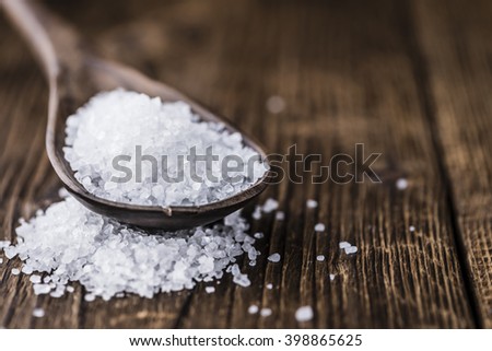 Coarse Salt (selective focus; close-up shot) on a dark vintage background