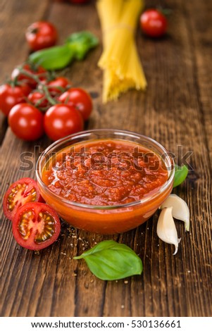 Fresh made Pasta Sauce (Tomato taste) on a vintage background (close-up shot)