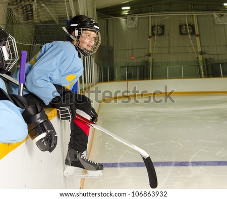 A Hockey Player on the Bench at the Rink is Ready to Jump on the Ice and Play