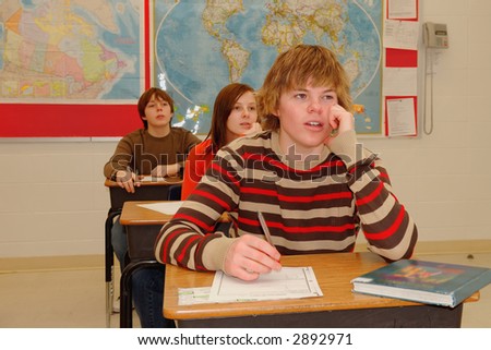 A student in class pays attention to school lesson.
