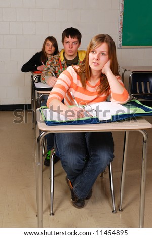A teenage student listens in high school class