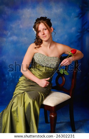 Portrait of a pretty high school graduate in prom dress.