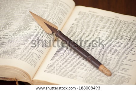 Antique dictionary with book knife on it