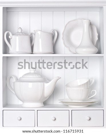 White shelf with vintage porcelain tableware