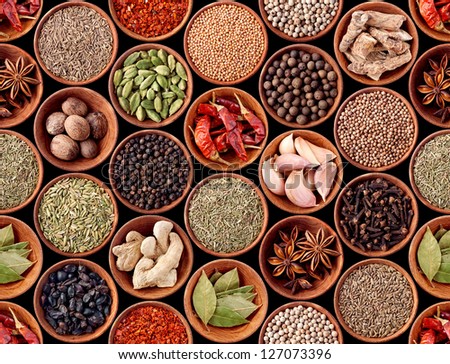 Seamless texture with spices and herbs over black background