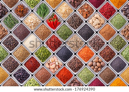 Seamless texture with spices and herbs over black background