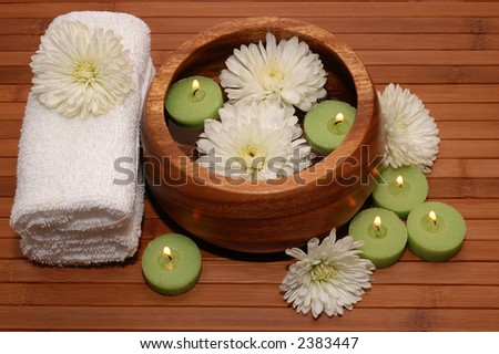 Floating green candles, chrysanthemum, towels