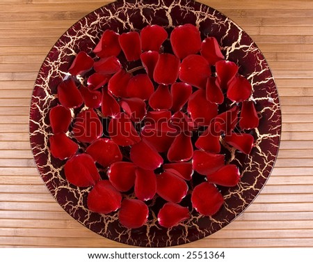 Floating fragrant rose petals in a handmade Italian dish