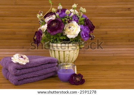 Colorful flowers, aromatic candle, and soft cotton towels