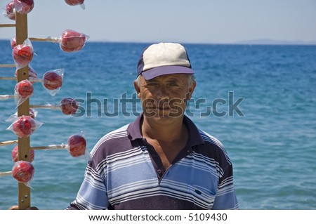 Candied apple salesman selling his apples at the beach