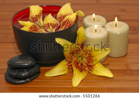 Spa Scene with aromatic candles, healing pebbles, and fragrant flowers