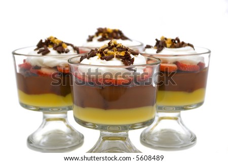 Trifle with chocolate pudding, vanilla pudding, strawberries, chocolate cake, whip cream, walnuts and chocolate curls