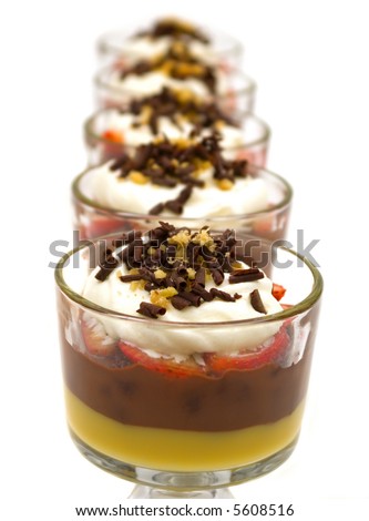 Trifle with chocolate pudding, vanilla pudding, strawberries, chocolate cake, whip cream, walnuts and chocolate curls
