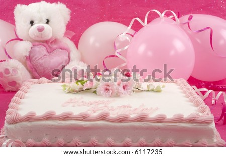 Delicious beautifully decorated birthday cake, teddy bear and balloons