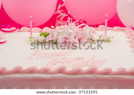 Delicious beautifully decorated birthday cake and balloons