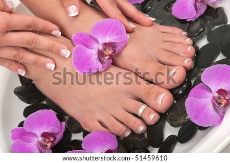 Pedicured feet and orchids