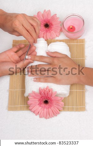 Male manicurist doing manicure to a female customer