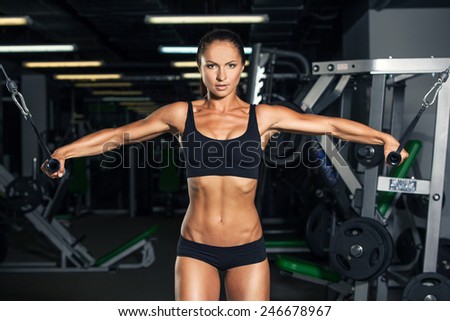 Woman on training apparatus in sports club. Fitness