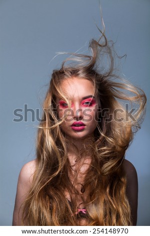 Portrait of a beautiful girl with fluttering hair