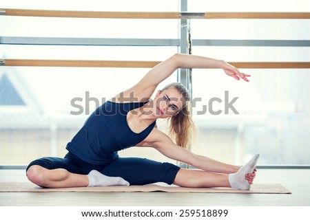 fitness, sport, training and lifestyle concept - woman doing exercises on mat in gym