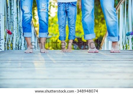 Happy Family on a Walk in Summer. Child with Parents Together. Feet Barefoot . Healthy Lifestyle. Dad Mom and Son. Spring Time.