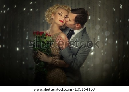 Happy couple with red roses