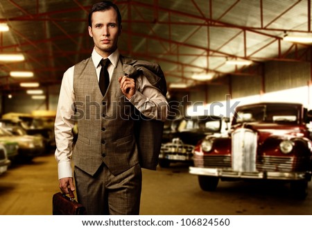 Businessman with a briefcase in garage
