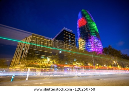 BARCELONA - NOVEMBER 24: Torre Agbar office building, illuminated at night, with traffic lights, on November 24, 2012 in Barcelona, Spain