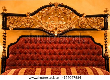 Back of expensive sofa with golden ornament