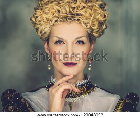 Portrait of beautiful haughty queen in royal dress