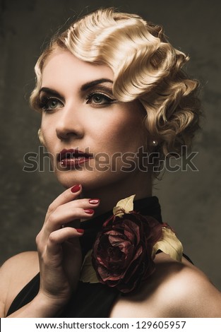 Elegant blond retro woman  in black dress with beautiful rose flower