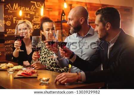 Group of friends having fun talk behind bar counter in a cafe