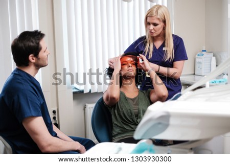Dentist and his assitant working in private practice.