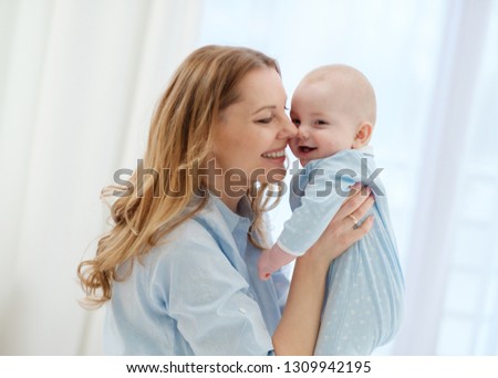 Happy middle aged mother with her child in a bed