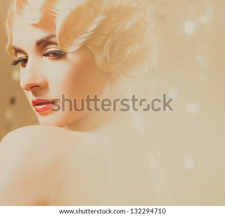 Elegant blond retro woman  in golden dress with beautiful hairdo and red lipstick