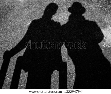 Two strangers shadows on pavement