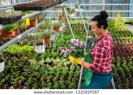 Black woman working in a botanical garden