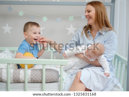 Happy middle aged mother with her children in a bed