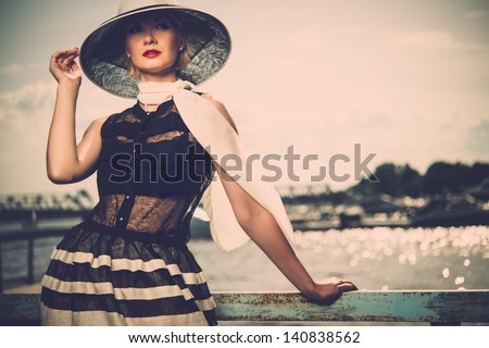 Woman In White Hat And Scarf Standing Near Old Pier Rails