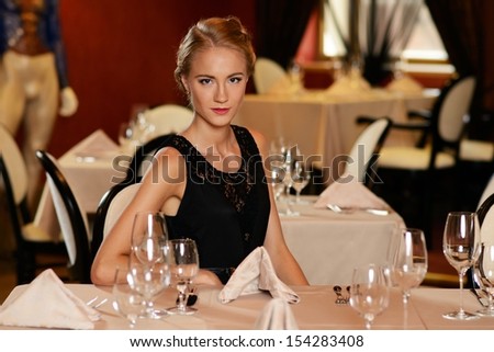 Beautiful young girl alone in a restaurant