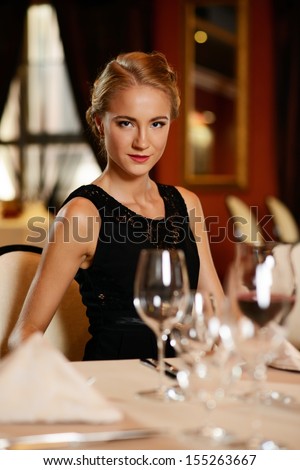 Beautiful young girl alone in a restaurant