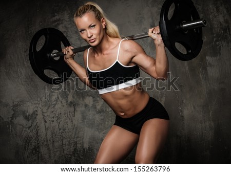 Beautiful Muscular Bodybuilder Doing Exercise With Weights