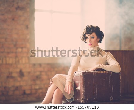 Beautiful Vintage Style Young Woman With Suitcase On A Train Station