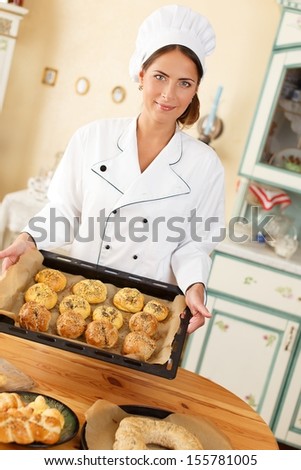 Woman holding baking tray with homemade baked goods