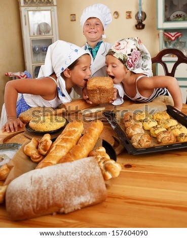 Happy children with table full of  homemade pastry