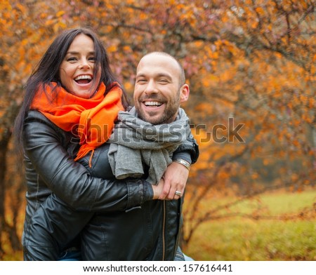 Happy middle-aged couple outdoors on beautiful autumn day