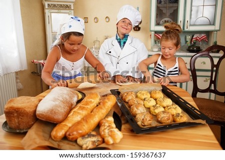 Happy children cooking homemade pastry