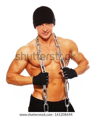 Handsome muscular man in beanie hat with chain