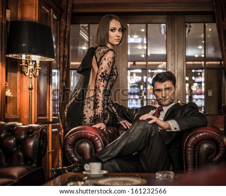 Elegant well-dressed couple in luxury interior